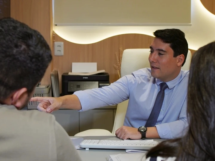 Mãos do médico segurando a mão da paciente em gesto de acolhimento